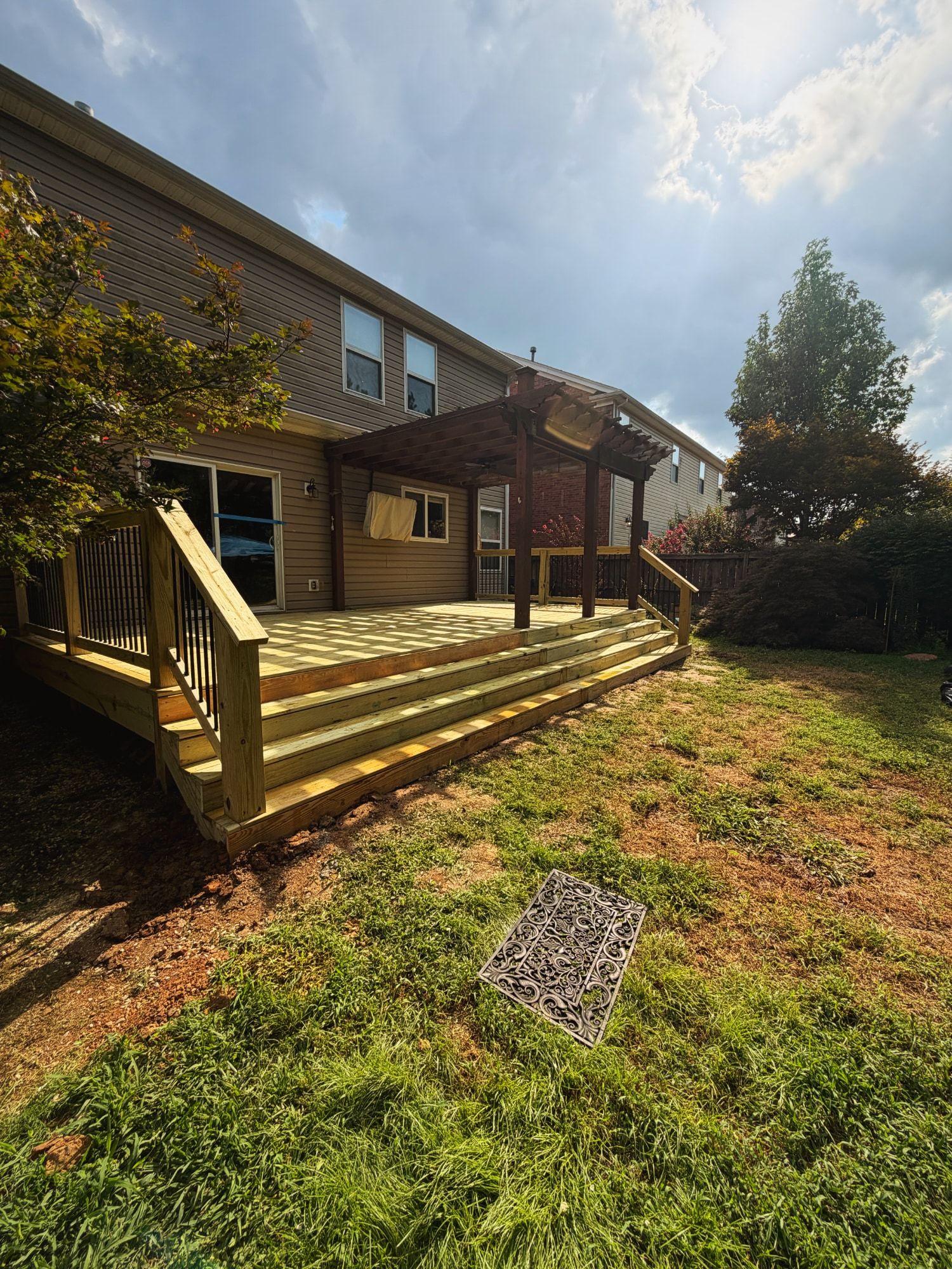 Pressure-treated deck under existing pergola