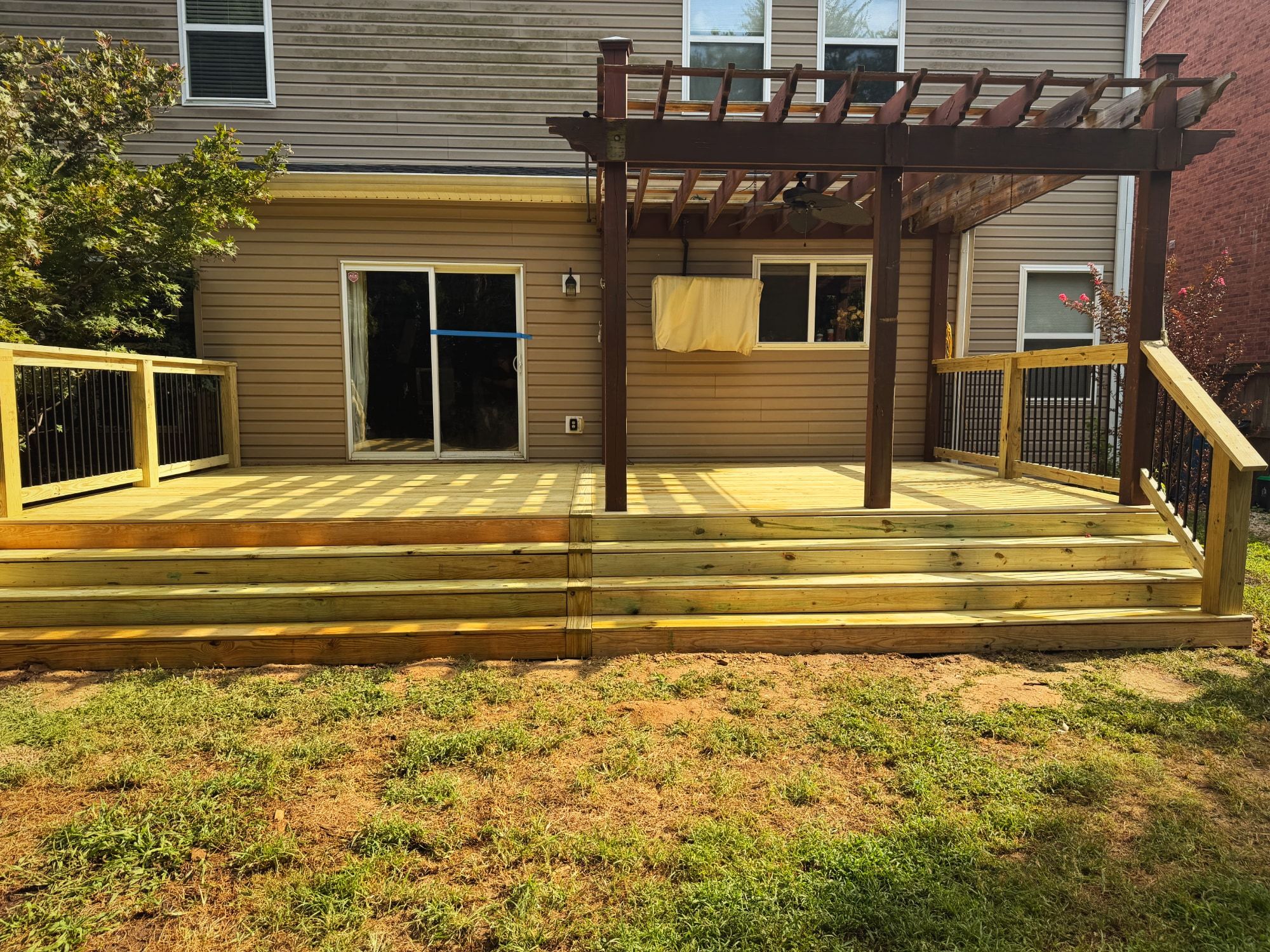 Wide deck with steps and black balusters