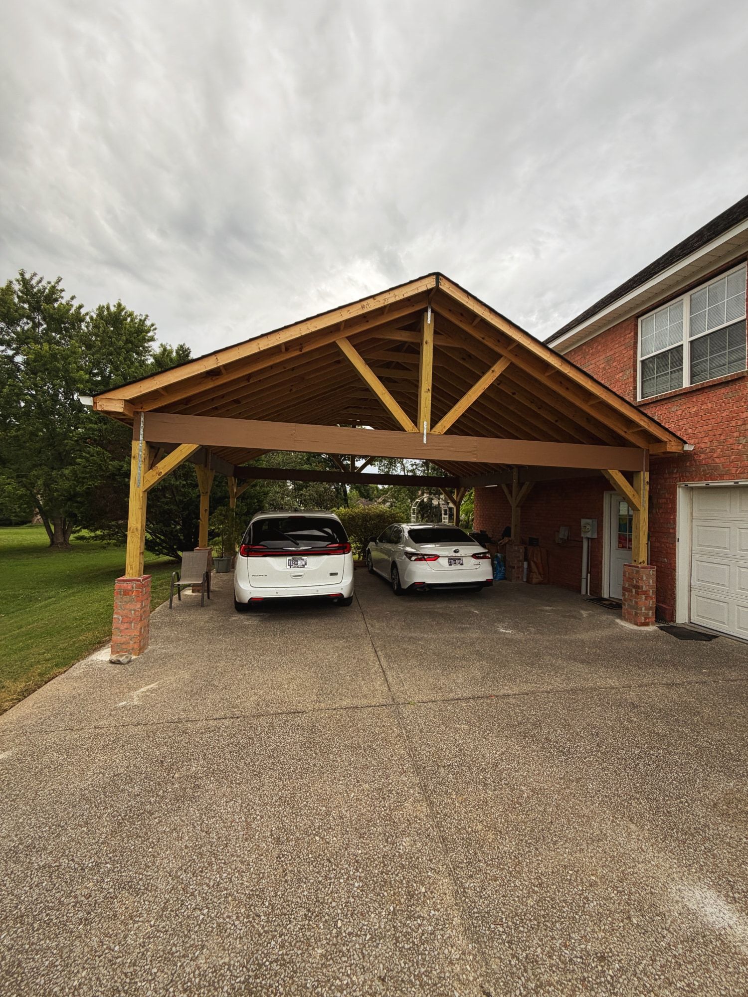 Timber carport with open truss ceiling